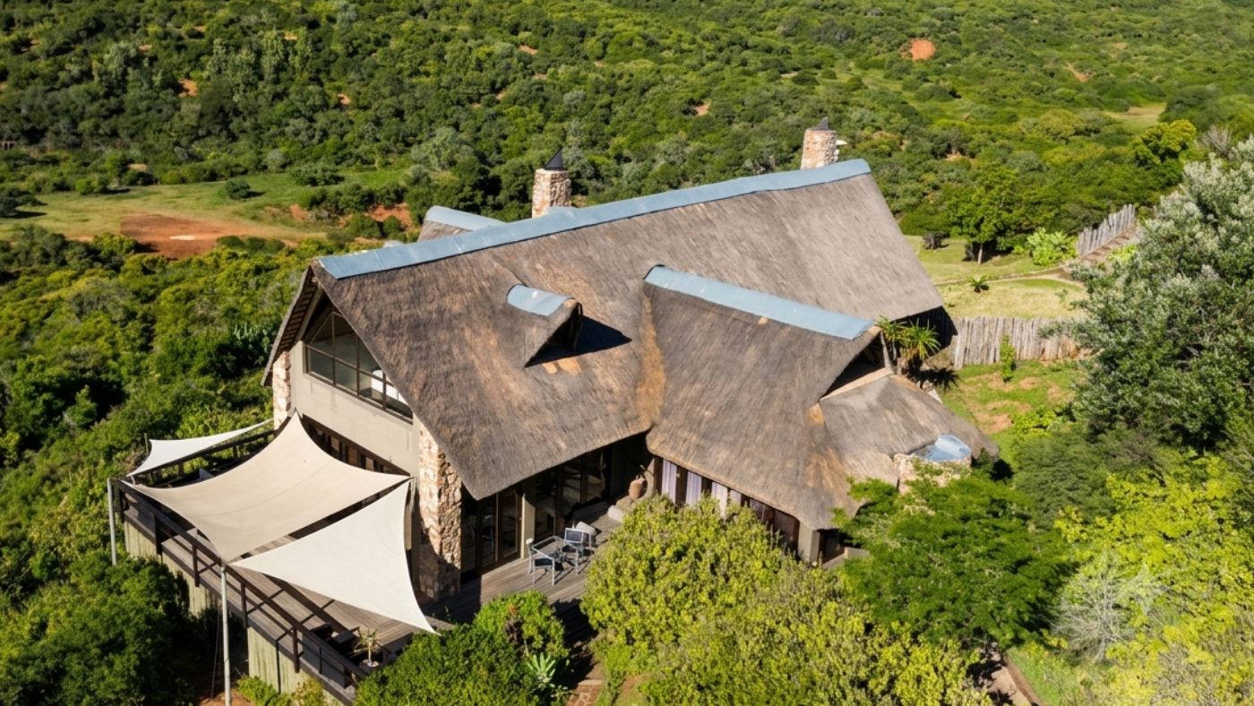 Aerial view of a large thatched lodge surrounded by bushveld in the Eastern Cape
